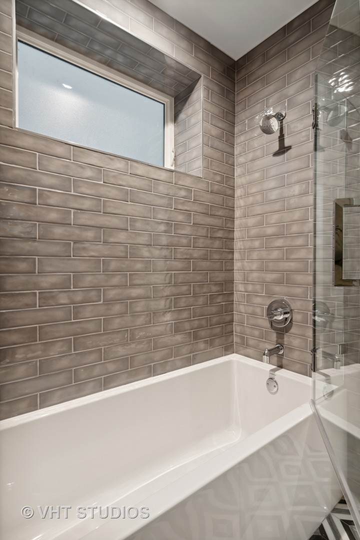 232 South Green Street, Unit 3N Chicago, IL 60607 - Photo 24 of 30 a bathroom with a bathtub and shower