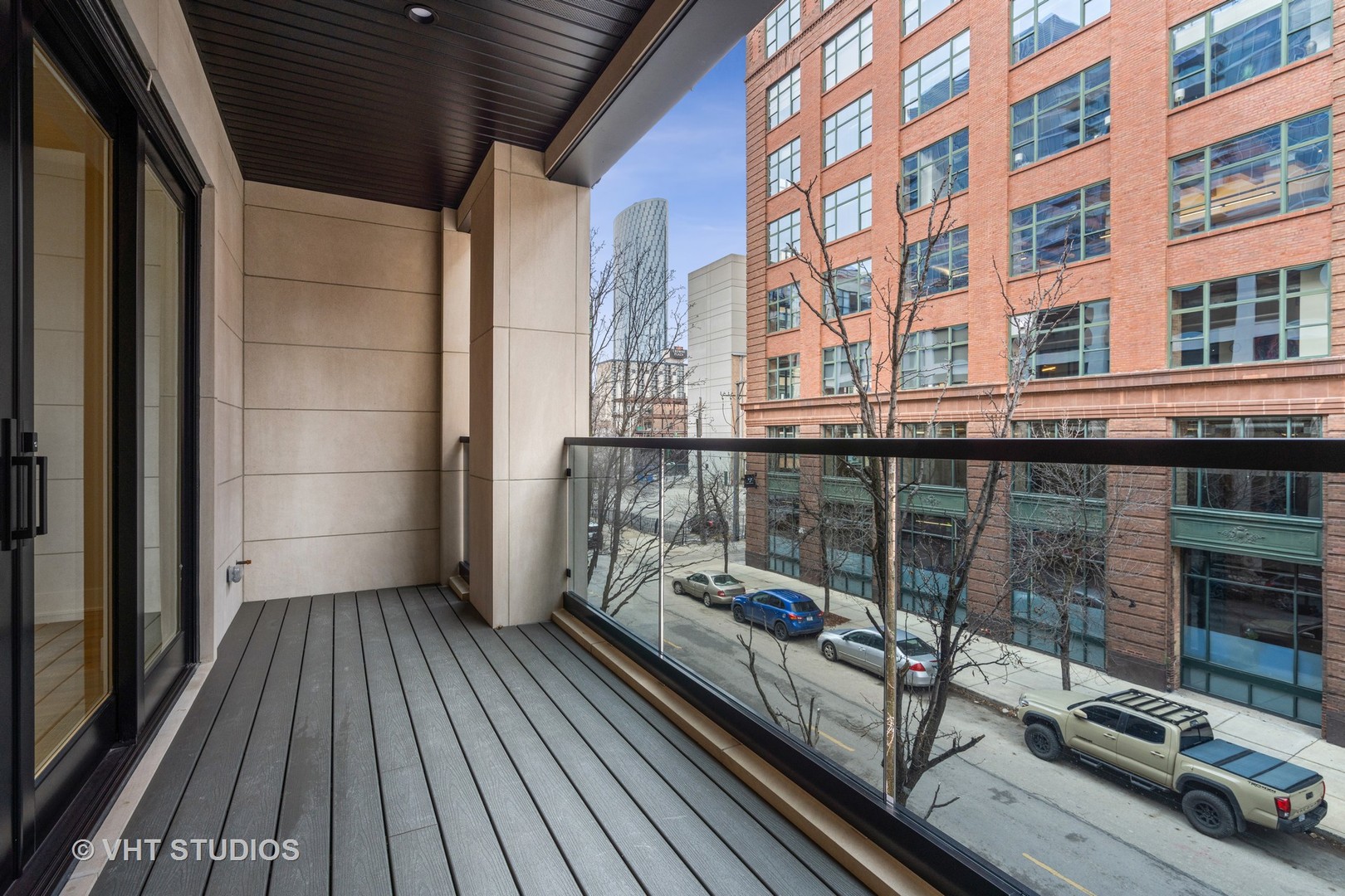 232 South Green Street, Unit 3N Chicago, IL 60607 - Photo 29 of 30 a view of a balcony with wooden floor and iron stairs