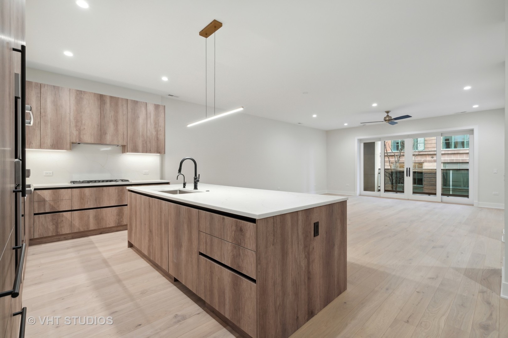 232 South Green Street, Unit 3N Chicago, IL 60607 - Photo 7 of 30 a kitchen with stainless steel appliances granite countertop a sink and a refrigerator