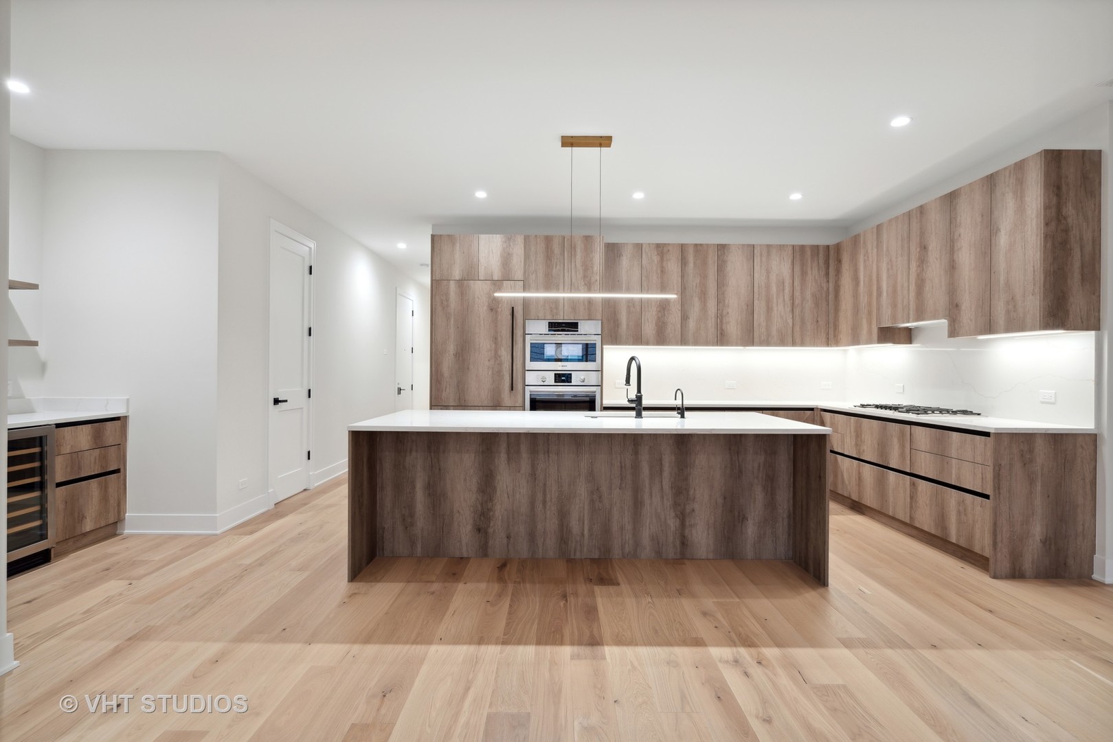 232 South Green Street, Unit 3N Chicago, IL 60607 - Photo 8 of 30 a kitchen with kitchen island granite countertop wooden cabinets a sink and dishwasher