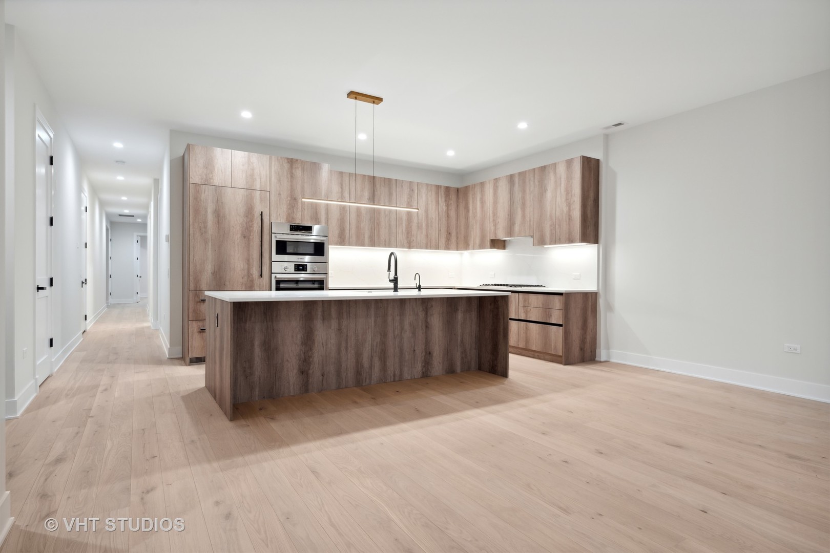232 South Green Street, Unit 3N Chicago, IL 60607 - Photo 9 of 30 a kitchen with stainless steel appliances kitchen island granite countertop a refrigerator and a sink