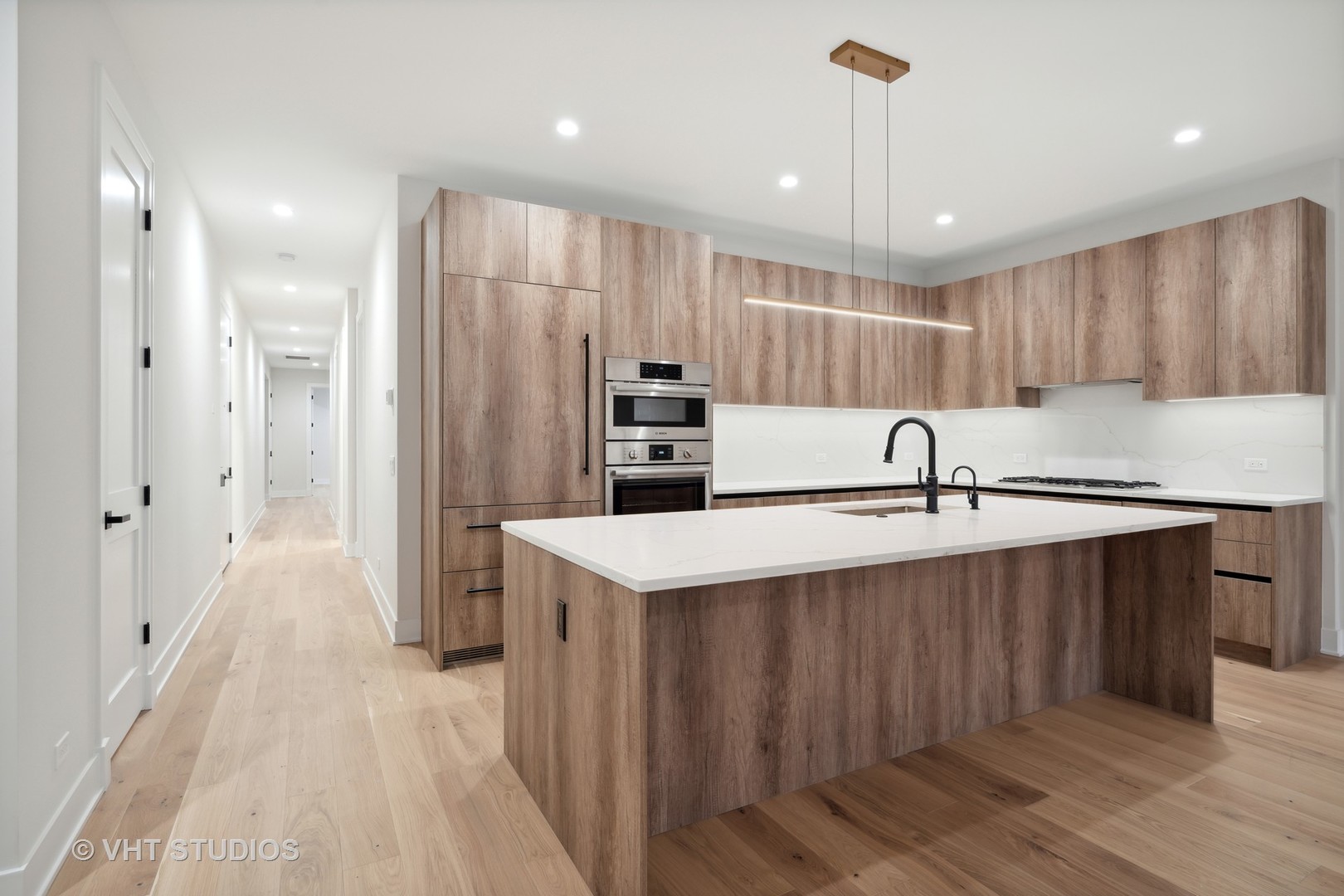 232 South Green Street, Unit 3N Chicago, IL 60607 - Photo 10 of 30 a kitchen with kitchen island a sink stainless steel appliances and cabinets
