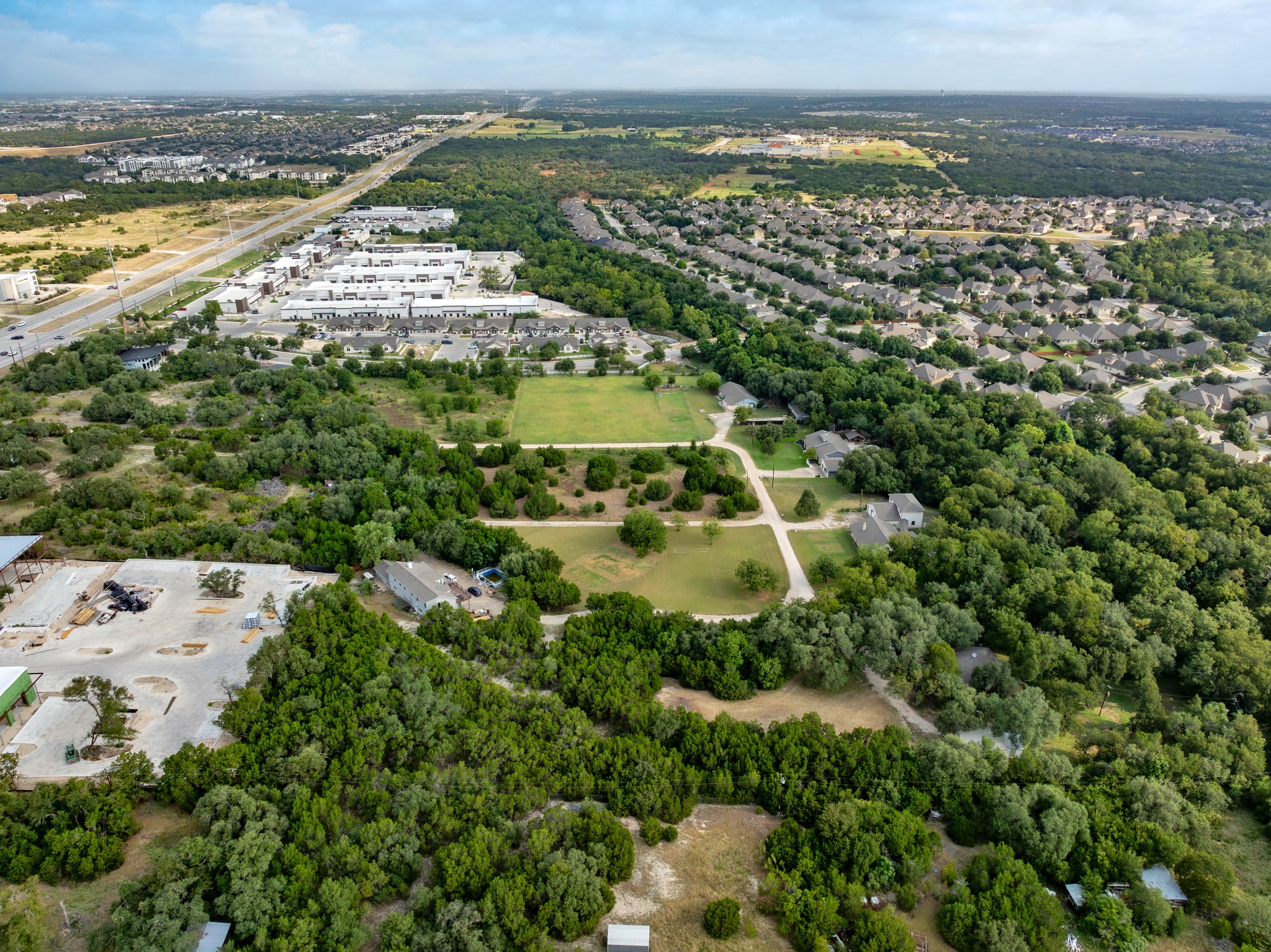 5021 Little Valley Road Leander, TX 78641 - Photo 29 of 32 Aerial context view of wooded acreage near commercial development and roadways.