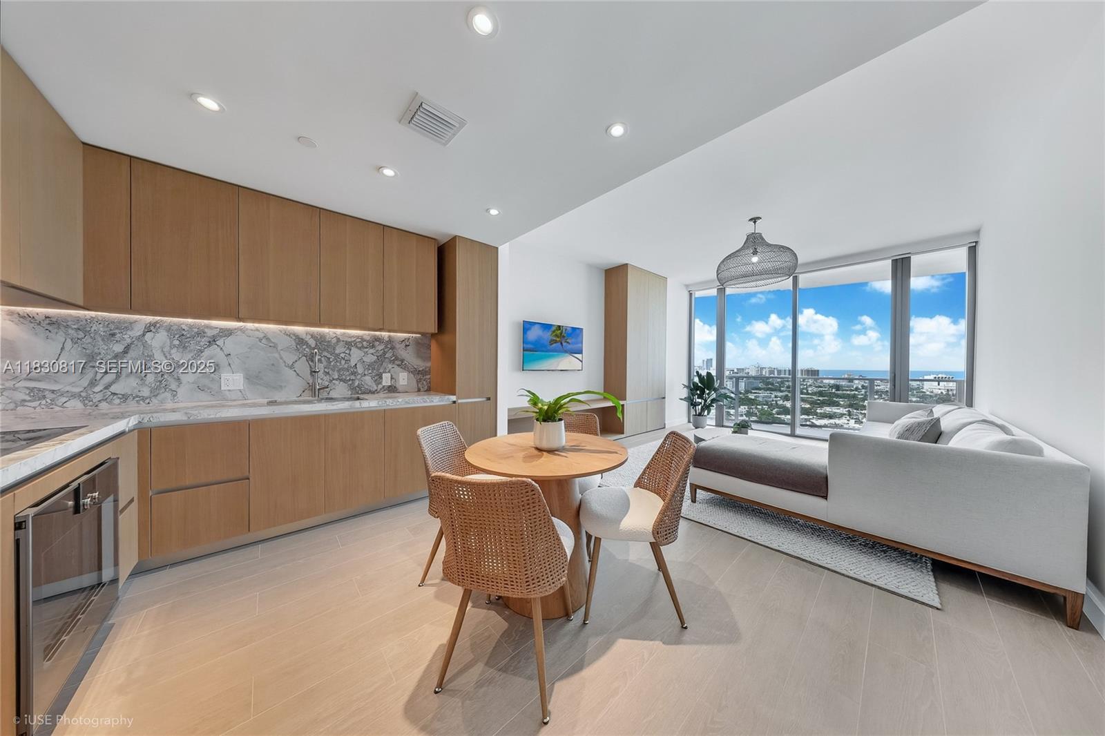 500 Alton Road, Unit 1906 Miami Beach, FL 33139 - Photo 2 of 19 a view of a dining room with furniture a rug and wooden floor