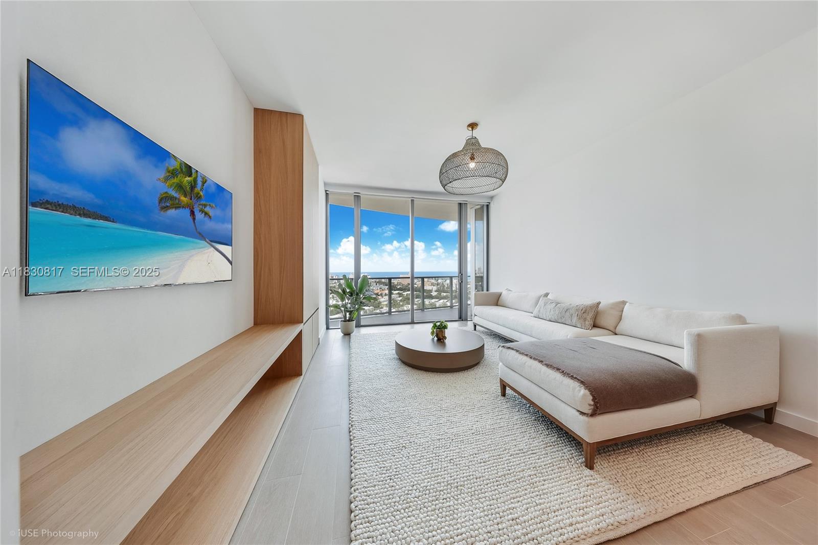 500 Alton Road, Unit 1906 Miami Beach, FL 33139 - Photo 5 of 19 a living room with furniture and a large window