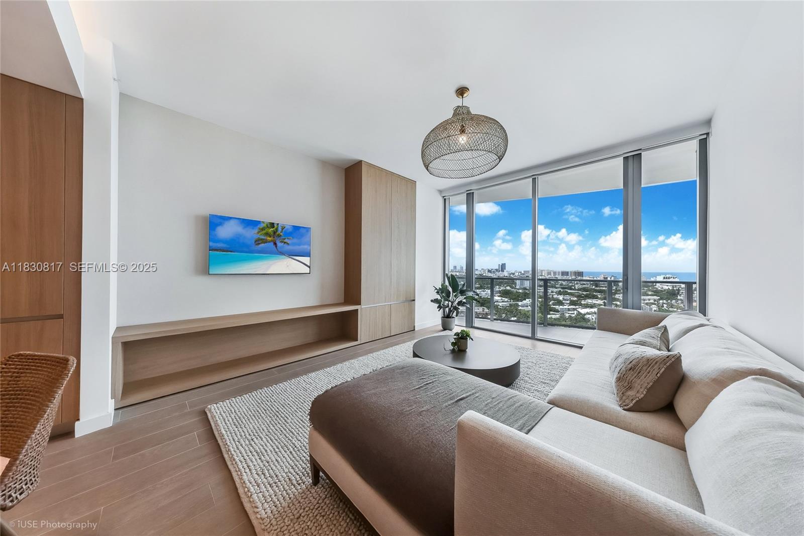 500 Alton Road, Unit 1906 Miami Beach, FL 33139 - Photo 6 of 19 a living room with furniture and a large window