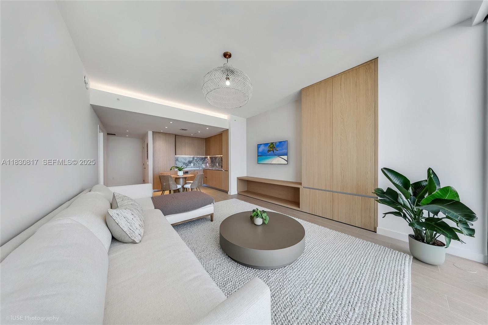 500 Alton Road, Unit 1906 Miami Beach, FL 33139 - Photo 7 of 19 a living room with furniture potted plant and a wooden floor