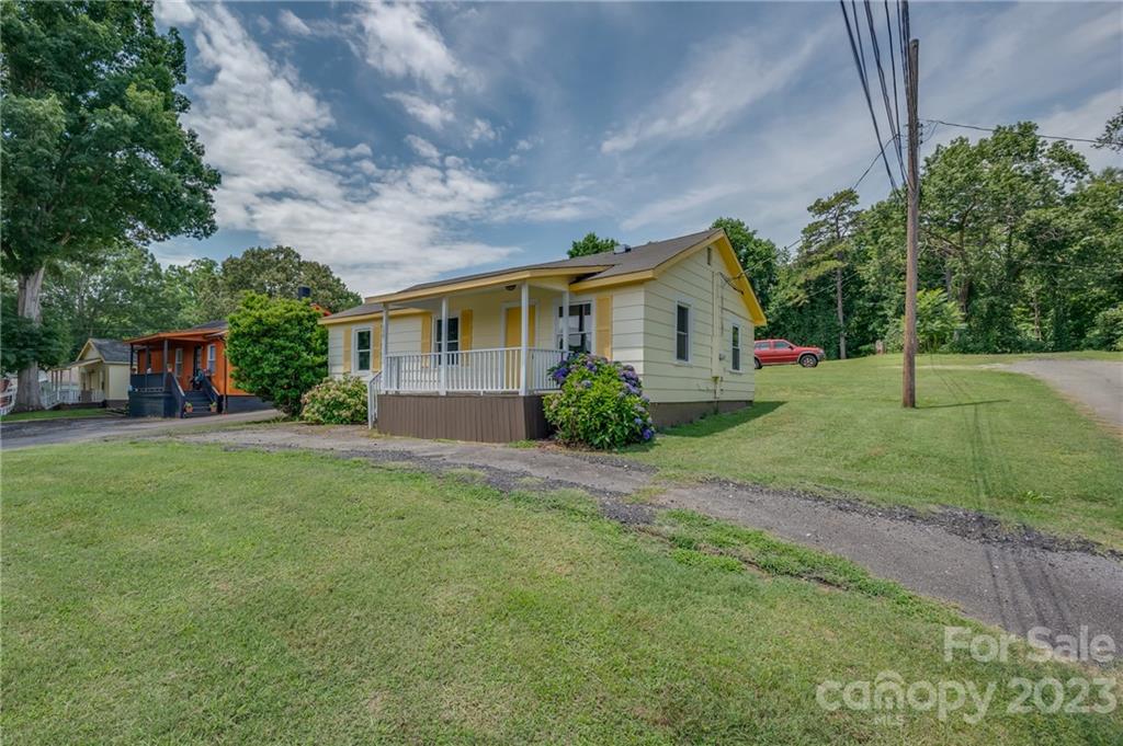 a front view of house with yard and green space