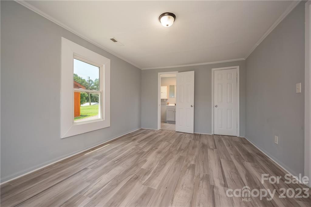 155 North Ridgecrest Avenue Rutherfordton, NC 28139 - Photo 11 of 18 a view of an empty room with wooden floor and a window