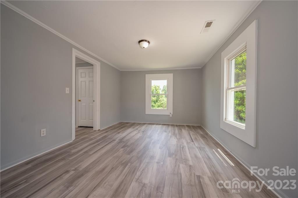 155 North Ridgecrest Avenue Rutherfordton, NC 28139 - Photo 12 of 18 wooden floor in an empty room with a window
