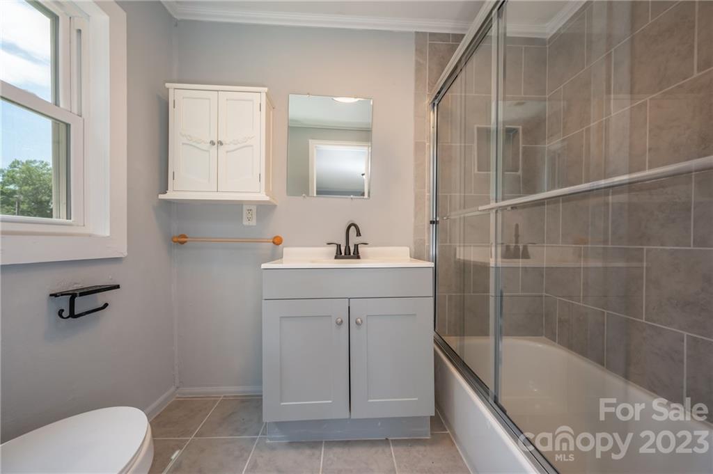 155 North Ridgecrest Avenue Rutherfordton, NC 28139 - Photo 13 of 18 a bathroom with a sink a toilet and shower