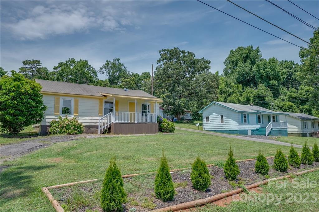 155 North Ridgecrest Avenue Rutherfordton, NC 28139 - Photo 18 of 18 a view of a house with backyard sitting area and garden