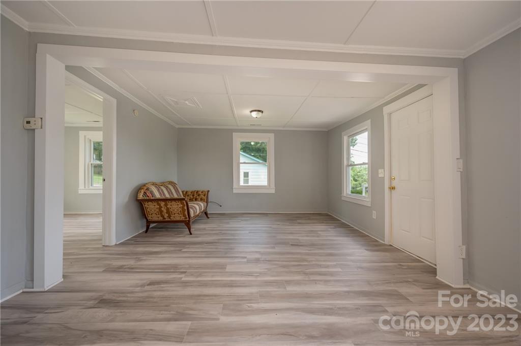 155 North Ridgecrest Avenue Rutherfordton, NC 28139 - Photo 4 of 18 a view of an empty room with window and wooden floor