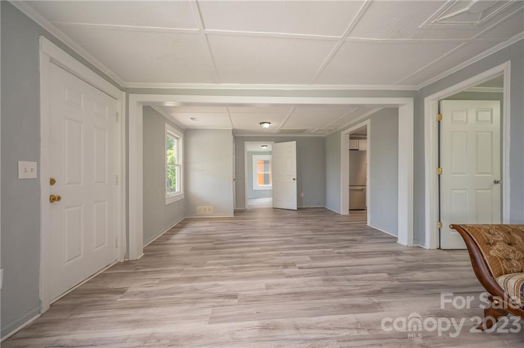 155 North Ridgecrest Avenue Rutherfordton, NC 28139 - Photo 6 of 18 a view of a hallway with wooden floor and bathroom
