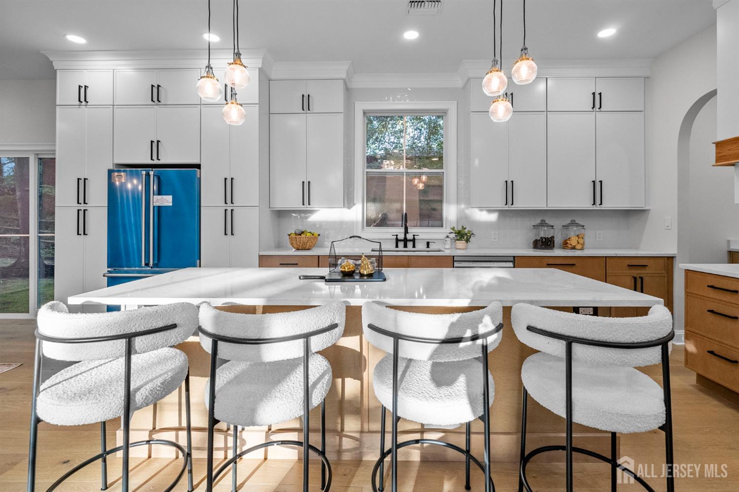 2 Beech Lane Edison, NJ 08820 - Photo 11 of 51 a kitchen with stainless steel appliances granite countertop a sink a stove a kitchen island and chairs with wooden floor