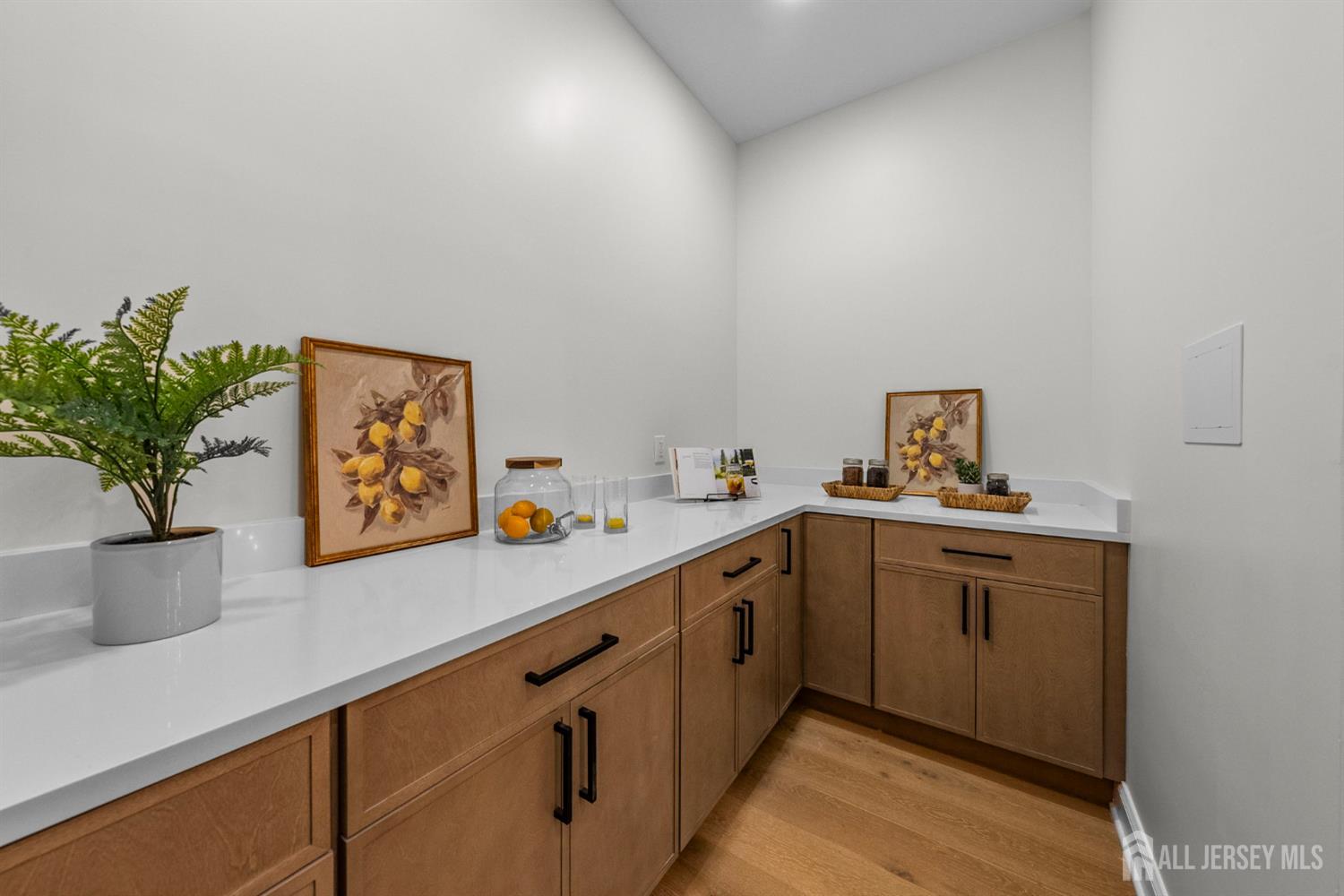 2 Beech Lane Edison, NJ 08820 - Photo 13 of 51 a kitchen with cabinets a potted plant on the counter and wooden floor