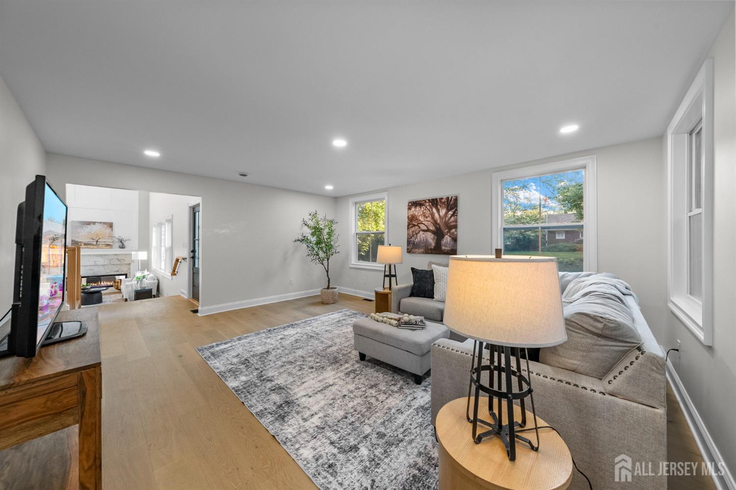 2 Beech Lane Edison, NJ 08820 - Photo 16 of 51 a living room with furniture a rug and a flat screen tv