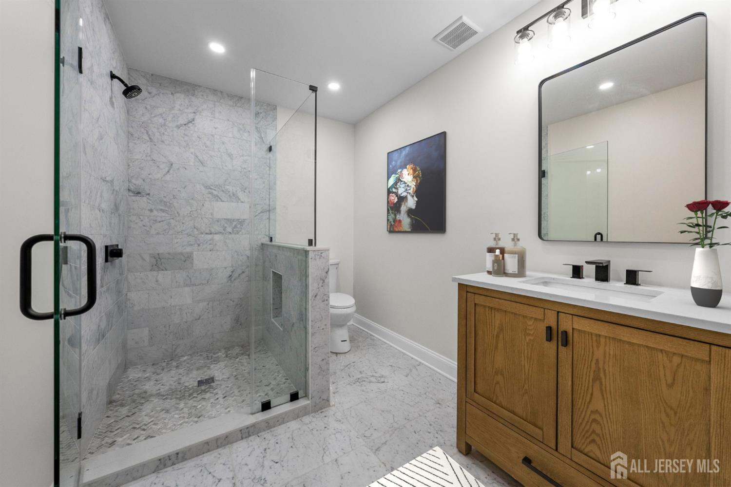 2 Beech Lane Edison, NJ 08820 - Photo 20 of 51 a bathroom with a shower sink and mirror