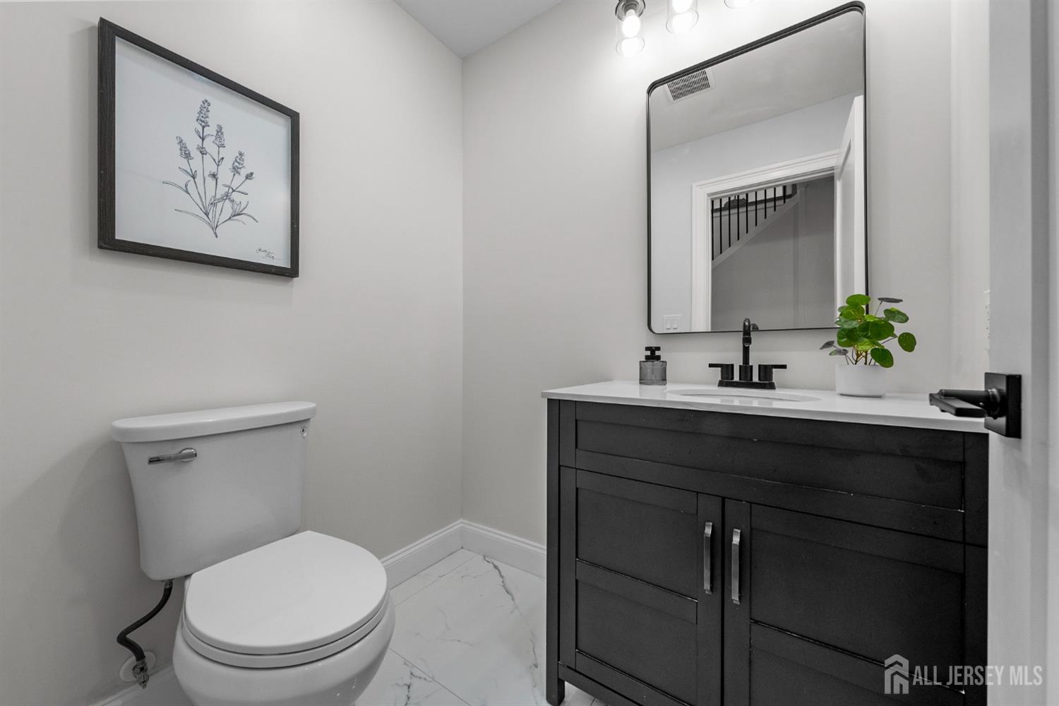 2 Beech Lane Edison, NJ 08820 - Photo 21 of 51 a bathroom with a toilet sink and mirror