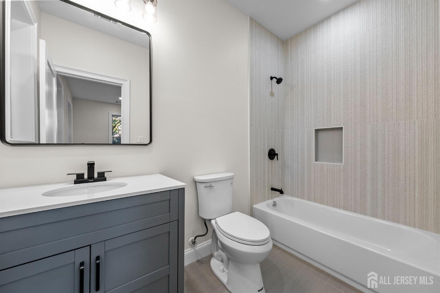 2 Beech Lane Edison, NJ 08820 - Photo 35 of 51 a bathroom with a toilet a sink a mirror and bathtub