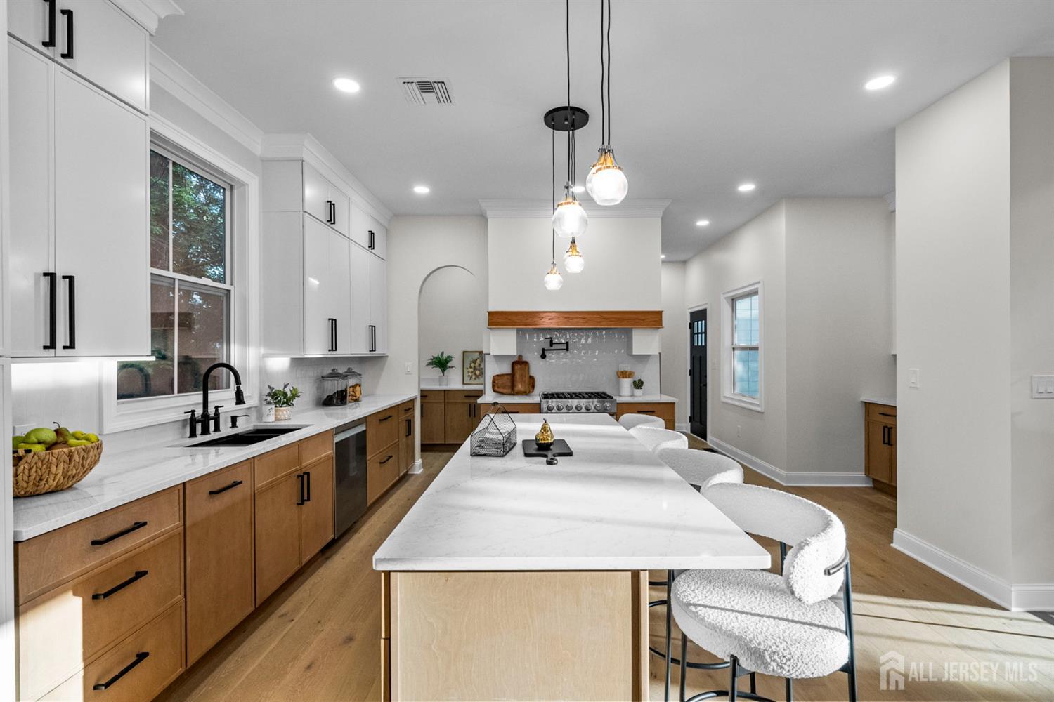 2 Beech Lane Edison, NJ 08820 - Photo 10 of 51 a large kitchen with cabinets a sink a stove and chairs