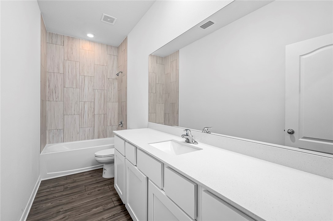 7926 105th Avenue Vero Beach, FL 32967 - Photo 17 of 18 a bathroom with a sink a toilet and shower