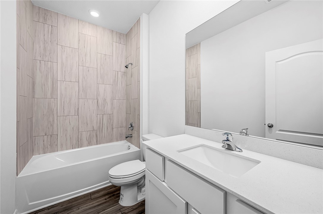 7926 105th Avenue Vero Beach, FL 32967 - Photo 18 of 18 a bathroom with a sink a toilet and a bathtub