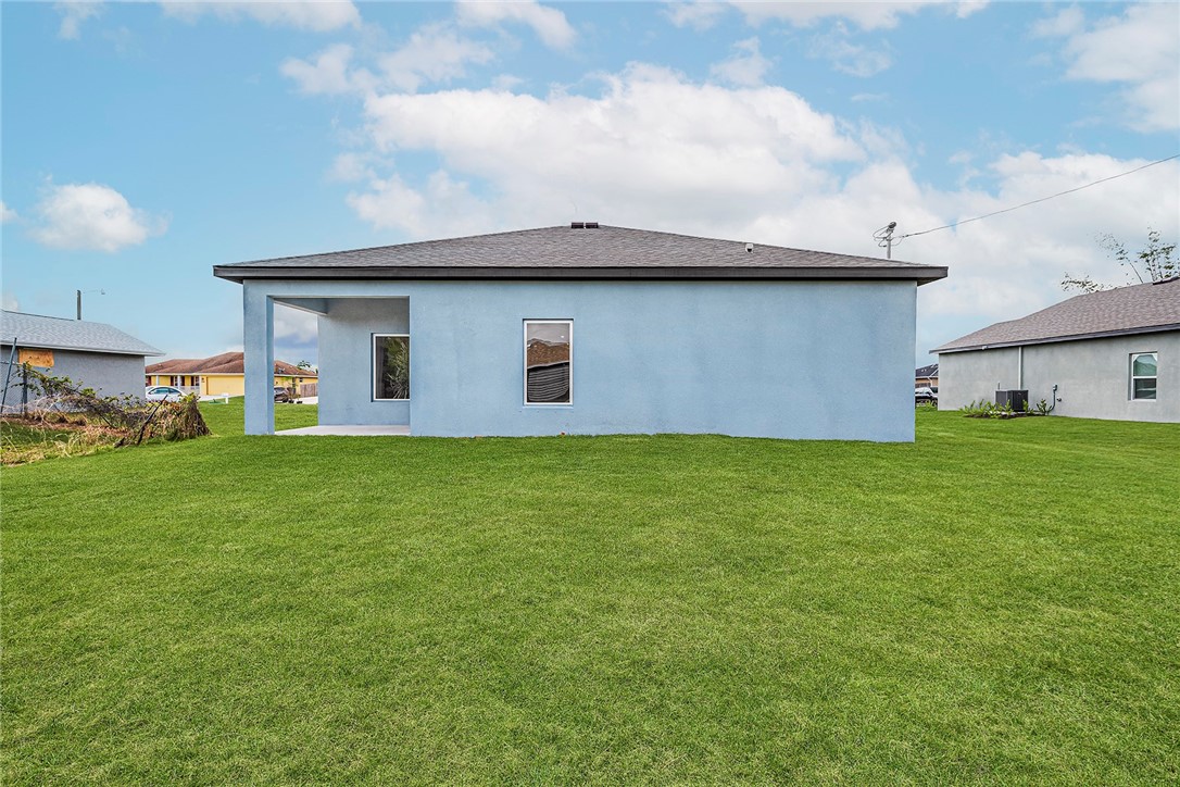 7926 105th Avenue Vero Beach, FL 32967 - Photo 3 of 18 a front view of a house with a yard and garage