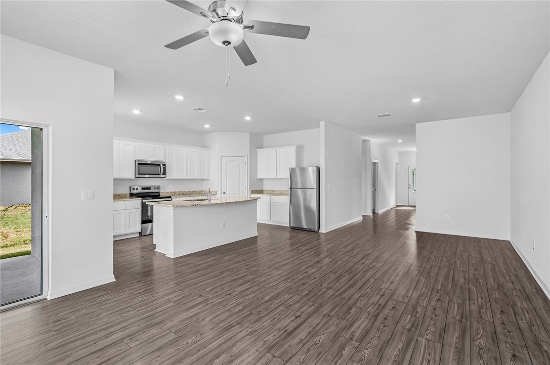 7926 105th Avenue Vero Beach, FL 32967 - Photo 4 of 18 a view of kitchen with refrigerator and microwave