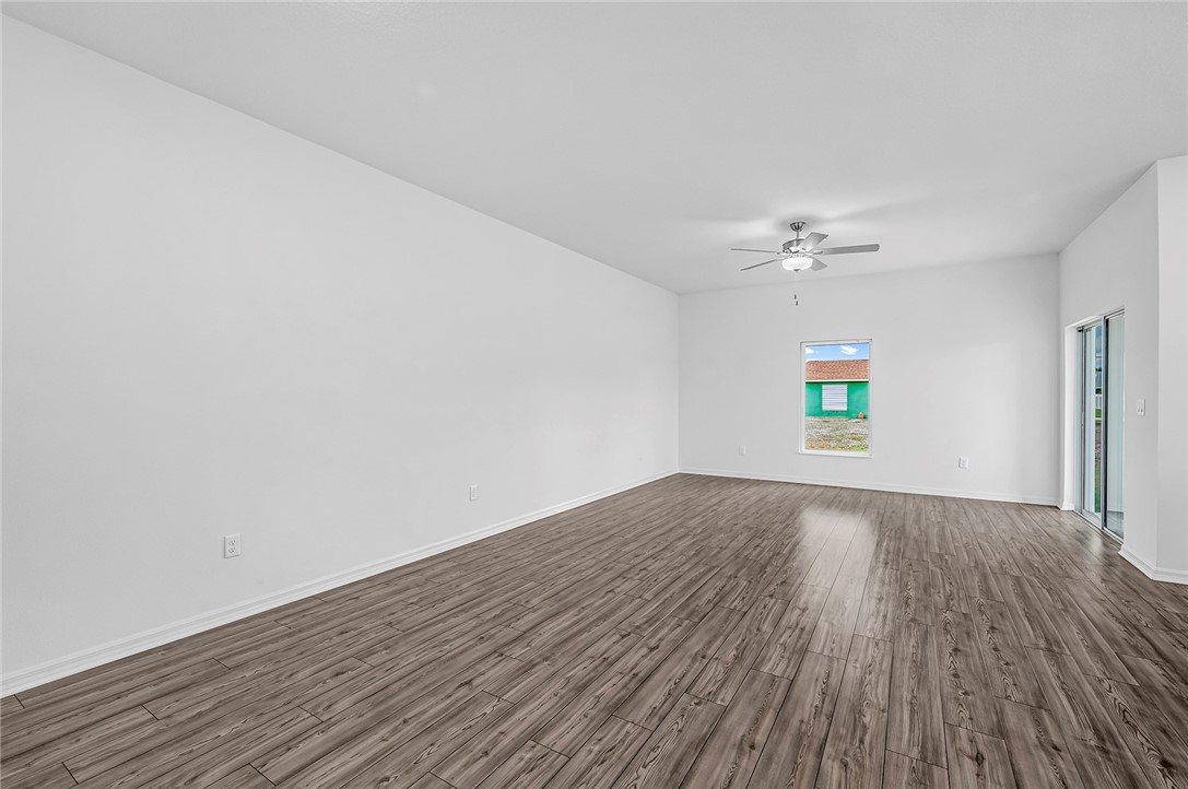7926 105th Avenue Vero Beach, FL 32967 - Photo 5 of 18 a view of an empty room and wooden floor