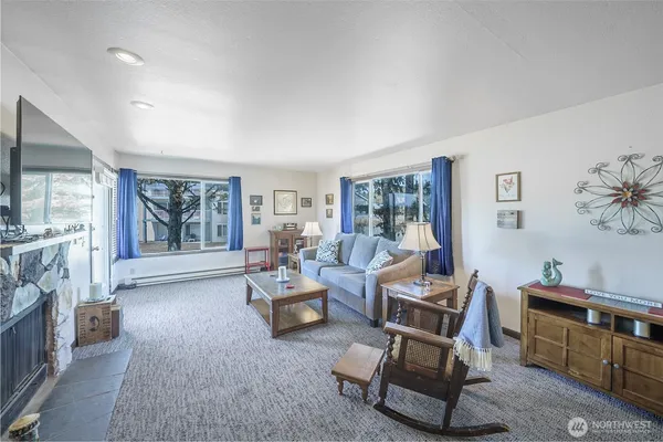 a living room with furniture and a floor to ceiling window