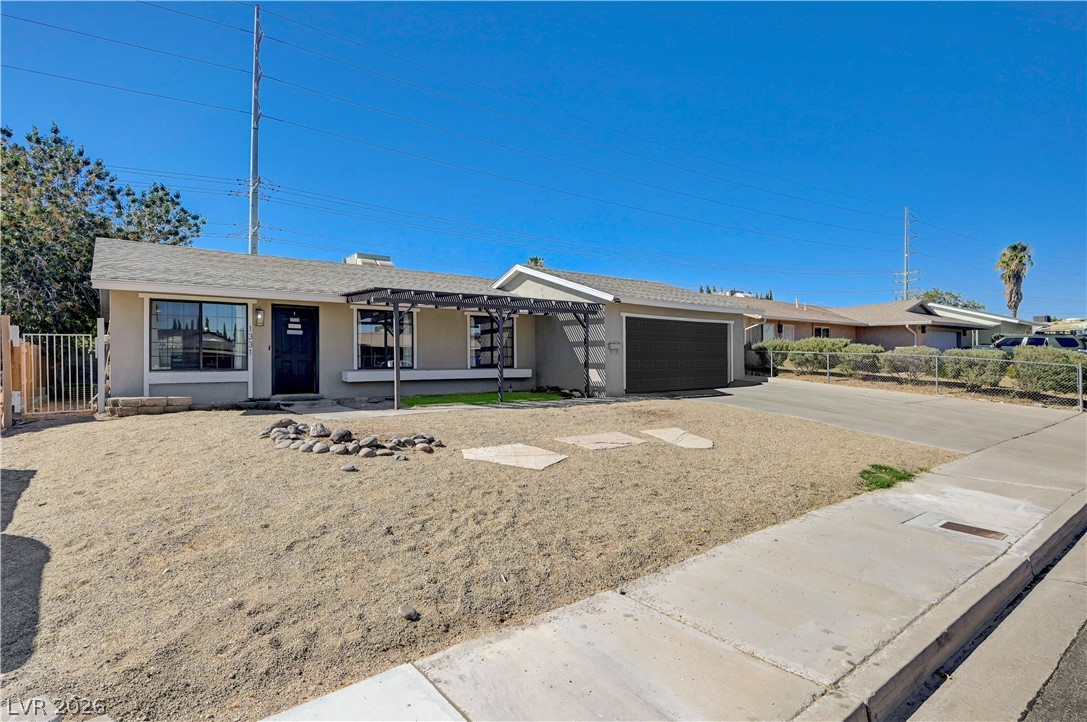 1331 Pinto Road Boulder City, NV 89005 - Photo 43 of 46 A classic ranch-style home features an attached garage, a low-maintenance xeriscaped front yard, and an inviting sidewalk.