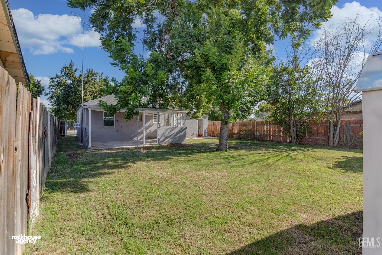 Undisclosed Address Bakersfield, CA 93308 - Photo 11 of 17 a backyard of a house with lots of green space