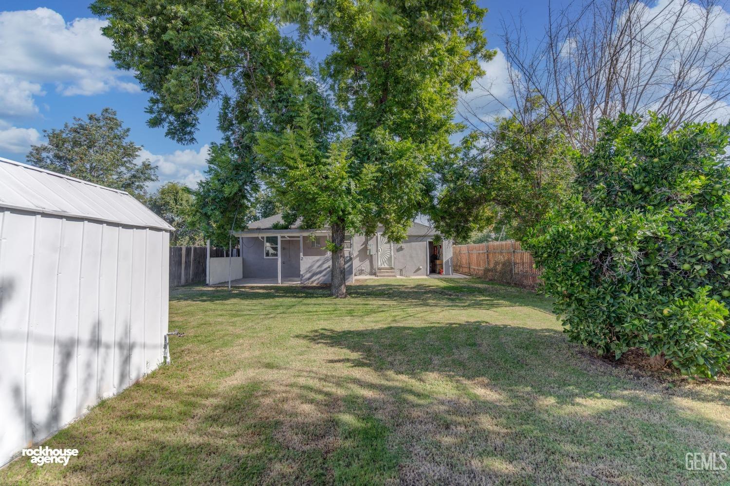 Undisclosed Address Bakersfield, CA 93308 - Photo 16 of 17 a backyard of a house with a garden and plants
