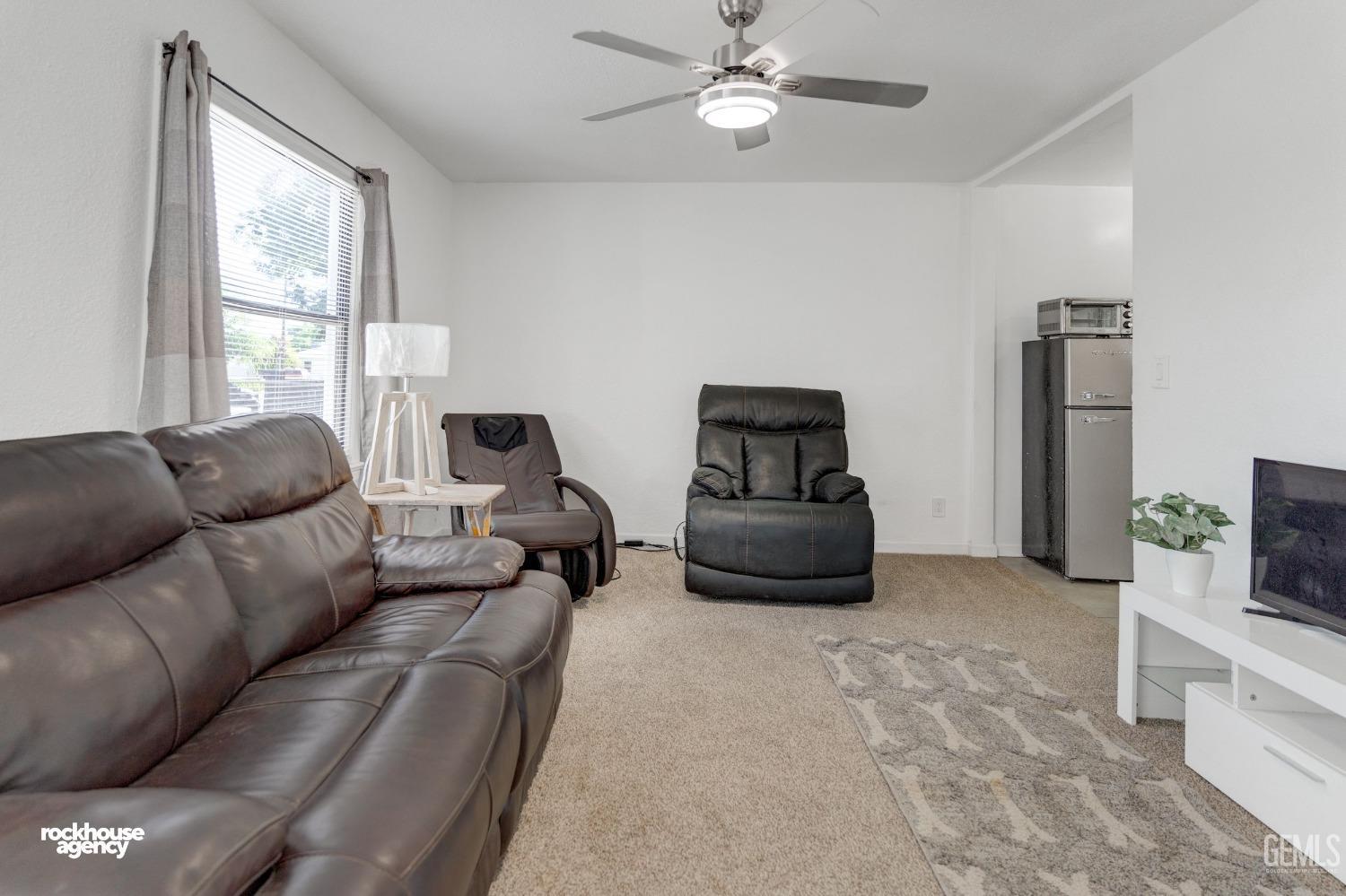 Undisclosed Address Bakersfield, CA 93308 - Photo 2 of 17 a living room with furniture and a flat screen tv