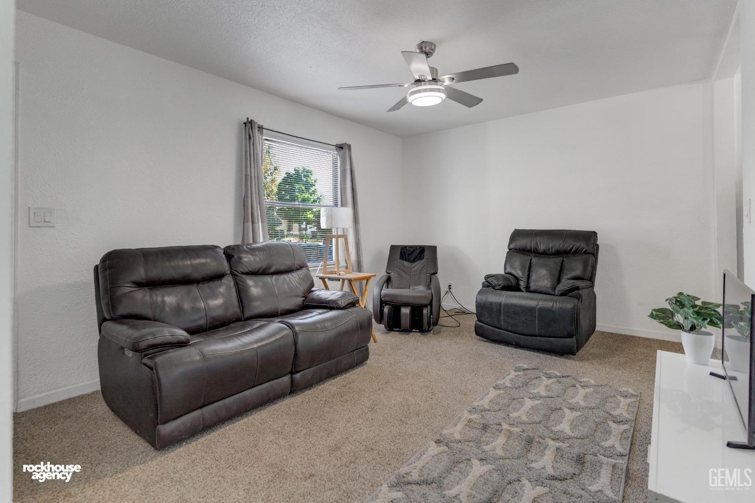 Undisclosed Address Bakersfield, CA 93308 - Photo 3 of 17 a living room with furniture a chandelier and a window