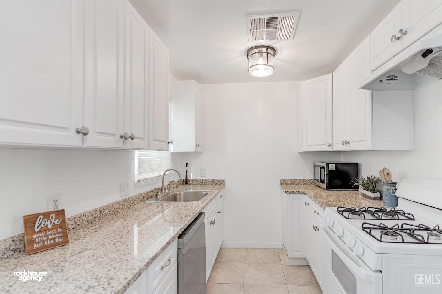 Undisclosed Address Bakersfield, CA 93308 - Photo 5 of 17 a kitchen with stainless steel appliances granite countertop a sink stove and cabinets
