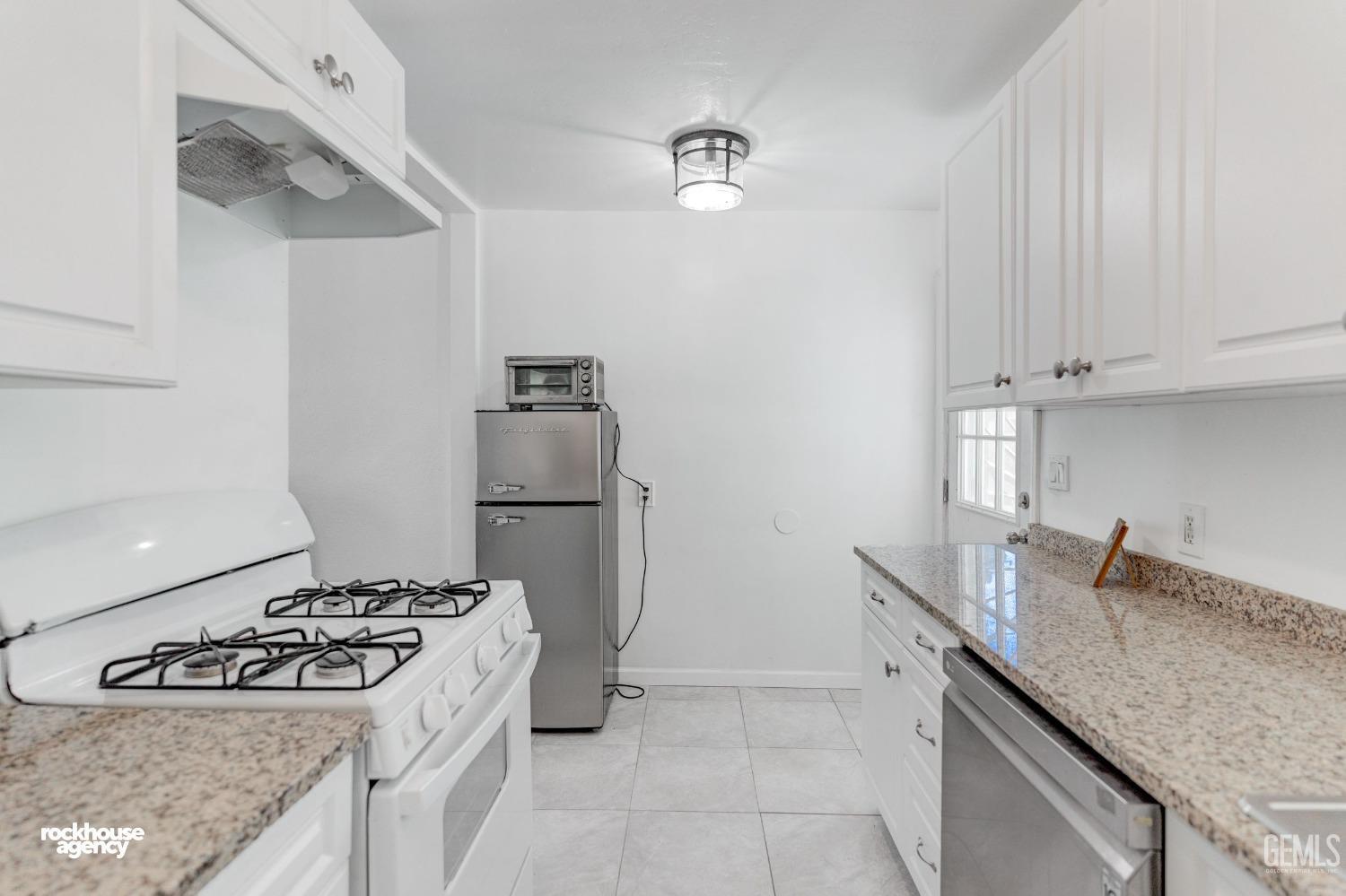 Undisclosed Address Bakersfield, CA 93308 - Photo 6 of 17 a kitchen with stainless steel appliances granite countertop a sink stove and refrigerator