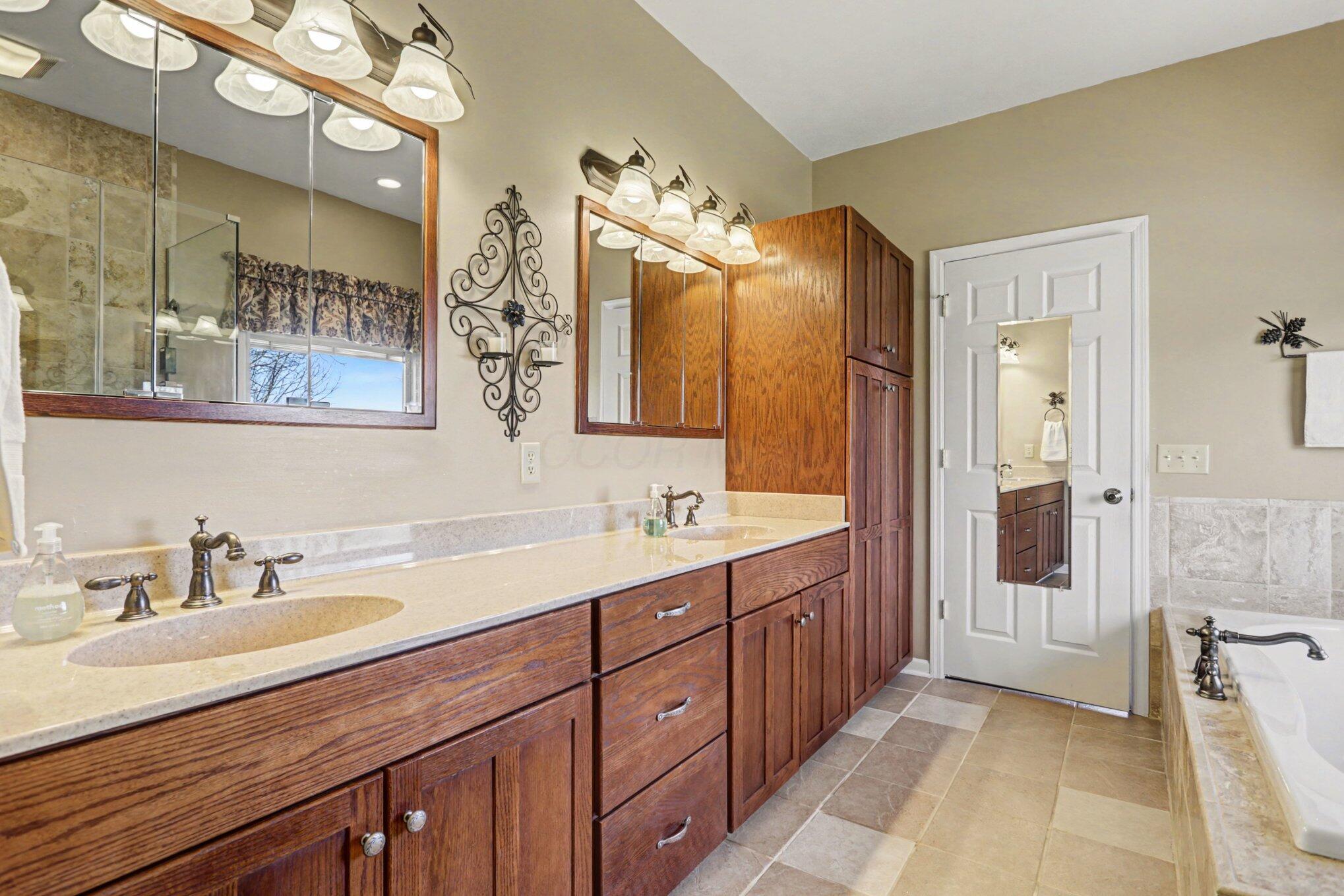 1855 Spring Valley Road London, OH 43140 - Photo 20 of 54 Tile floor, double sink vanity, linen cabinet.