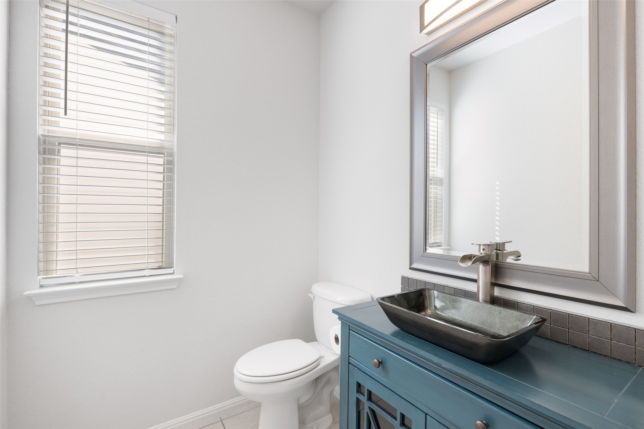 183 Concho Creek Loop Leander, TX 78641 - Photo 14 of 35 a bathroom with a granite countertop sink and a toilet