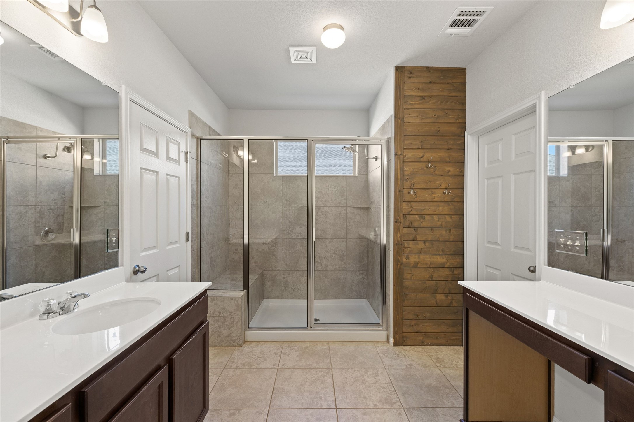 183 Concho Creek Loop Leander, TX 78641 - Photo 20 of 35 a bathroom with a shower sink and mirror
