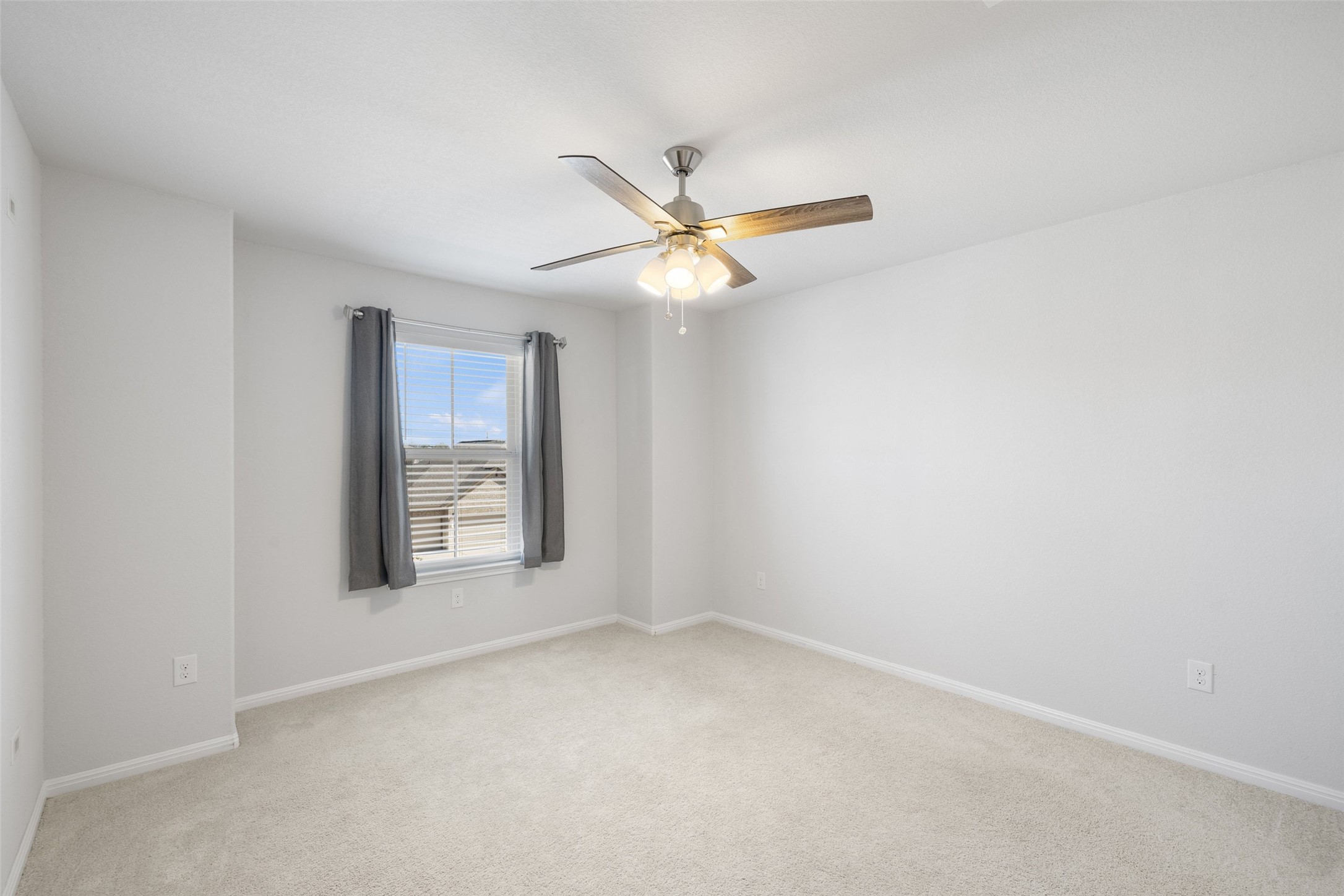 183 Concho Creek Loop Leander, TX 78641 - Photo 25 of 35 an empty room with windows and fan