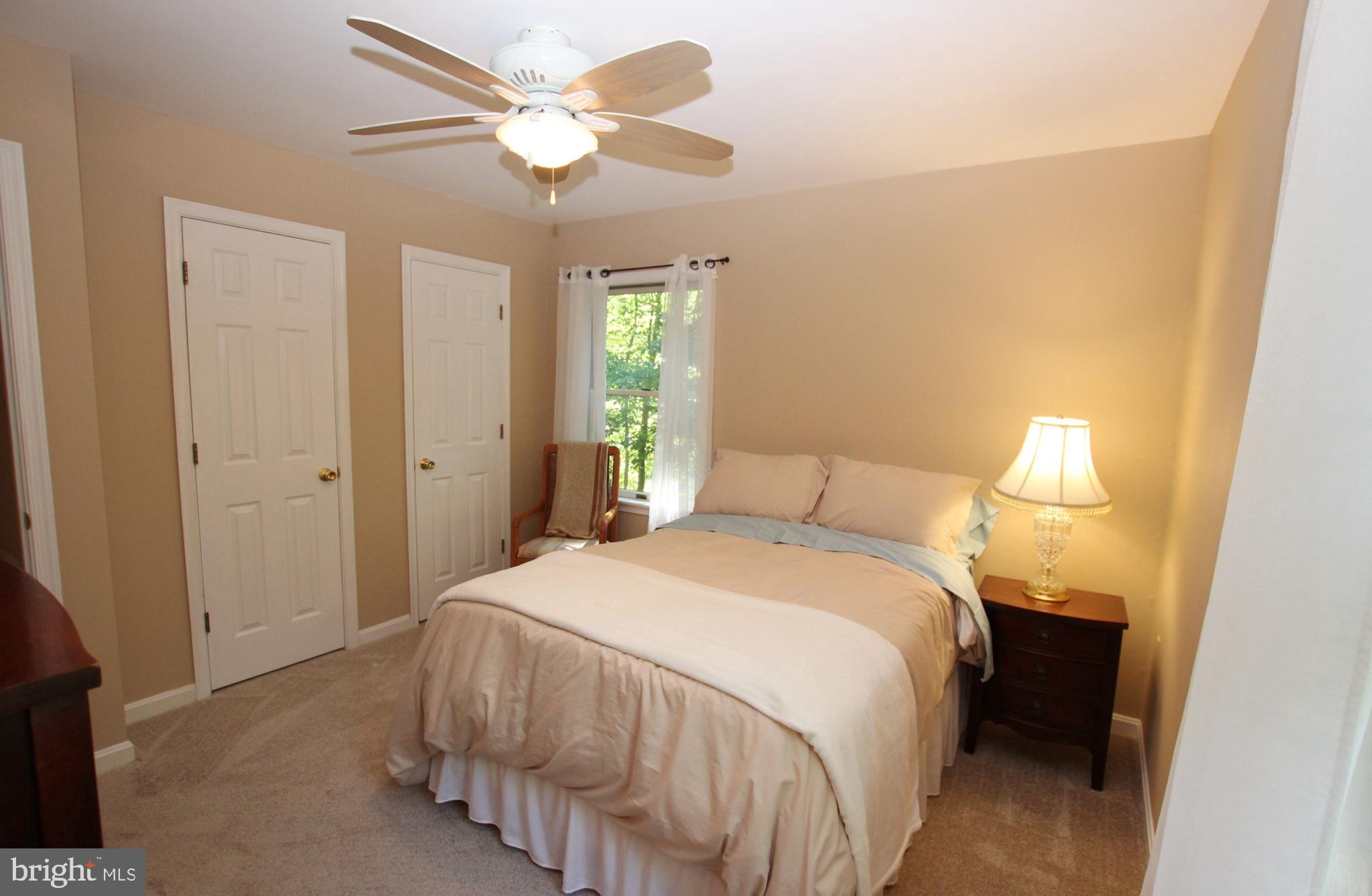 426 Mad Hatter Road Harpers Ferry, WV 25425 - Photo 22 of 31 a bedroom with a bed and a chandelier
