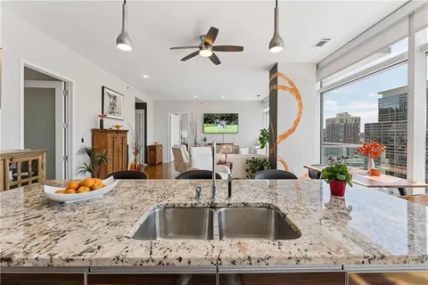 a kitchen with stainless steel appliances granite countertop a refrigerator and a stove top oven