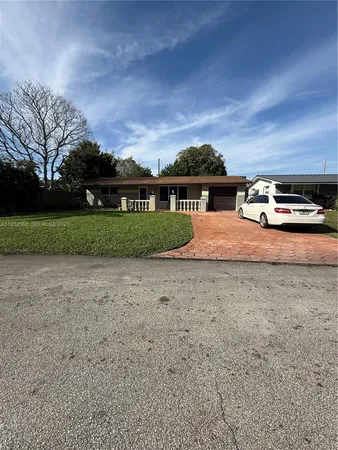a view of a car parked in front of a house