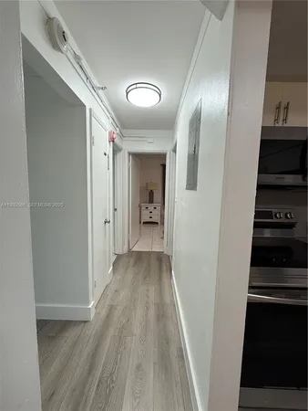 a view of a hallway with wooden shelves