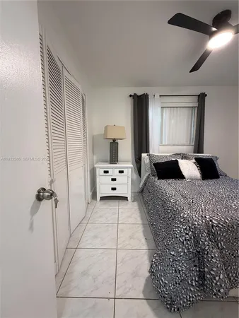 a bathroom with a granite countertop sink a toilet a mirror and shower