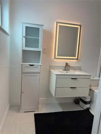 a bathroom with a double vanity sink toilet and shower