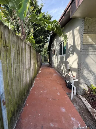 a view of a backyard with large trees