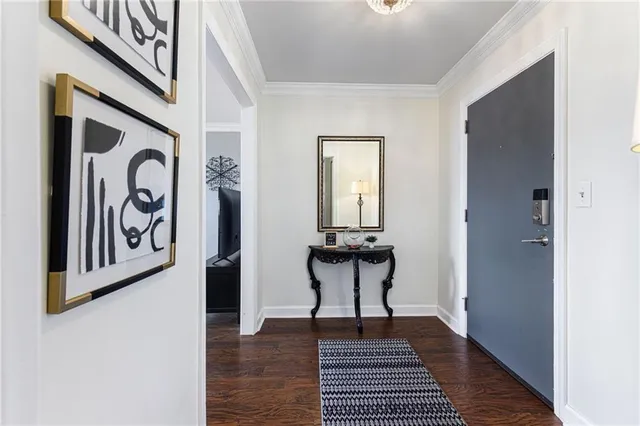 a view of a hallway with wooden floor and a dining table